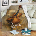 Violin throw blanket draped over a sofa with dramatic instrument artwork and musical notes in a cozy room