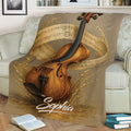 Close lifestyle view of a violin blanket featuring detailed wood grain, flowing sheet music, and golden accents