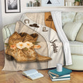 Cowgirl throw blanket draped over a sofa with Western boot artwork, floral details, and warm rustic colors