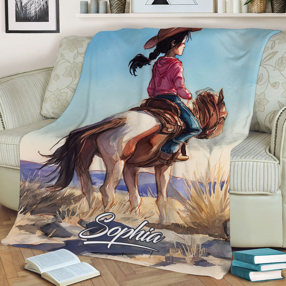 Western cowgirl riding artwork shown across a blanket draped over a sofa