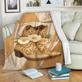 Cowgirl blanket draped over a sofa with decorative Western boots and floral artwork