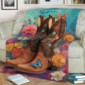 Cowgirl-inspired blanket displayed on a sofa with floral cowboy boots and vibrant botanical artwork