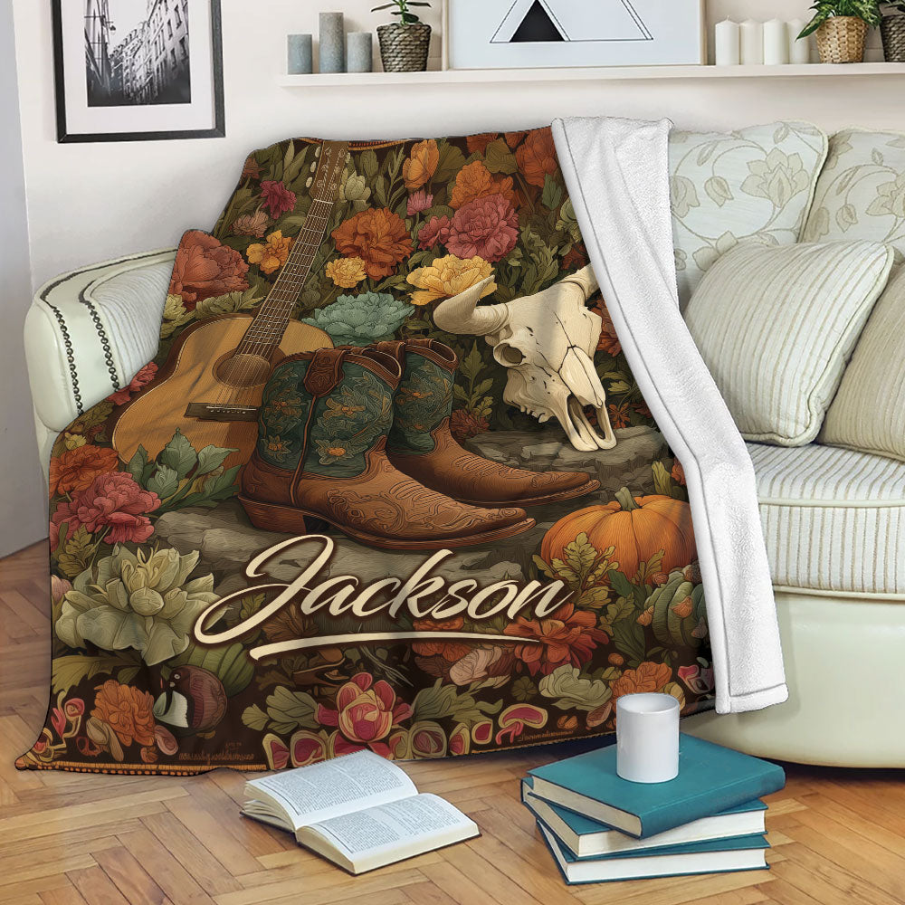 Cowgirl blanket draped over a sofa with Western boots, guitar and longhorn skull design