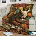 Rustic cowgirl throw blanket displayed on a couch with boots, guitar and Western skull artwork
