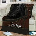 Equestrian horse blanket styled across a sofa with detailed black horse artwork