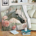 Horse throw blanket draped over a sofa with a white horse portrait, floral accents, and pastel vintage styling