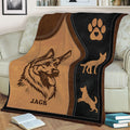 Close-up German Shepherd blanket design with paw print, dog silhouettes, and rustic brown tones