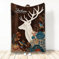Deer throw blanket with a white woodland stag, colorful flowers, birds, and rustic woodgrain artwork