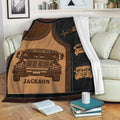 School bus blanket draped over a sofa with retro bus illustrations and warm brown artwork