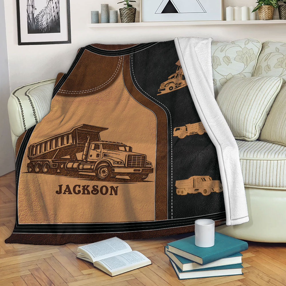 Dump truck blanket draped over a sofa, featuring industrial construction vehicle artwork