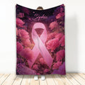 Breast cancer awareness blanket with a pink ribbon surrounded by vibrant pink flowers