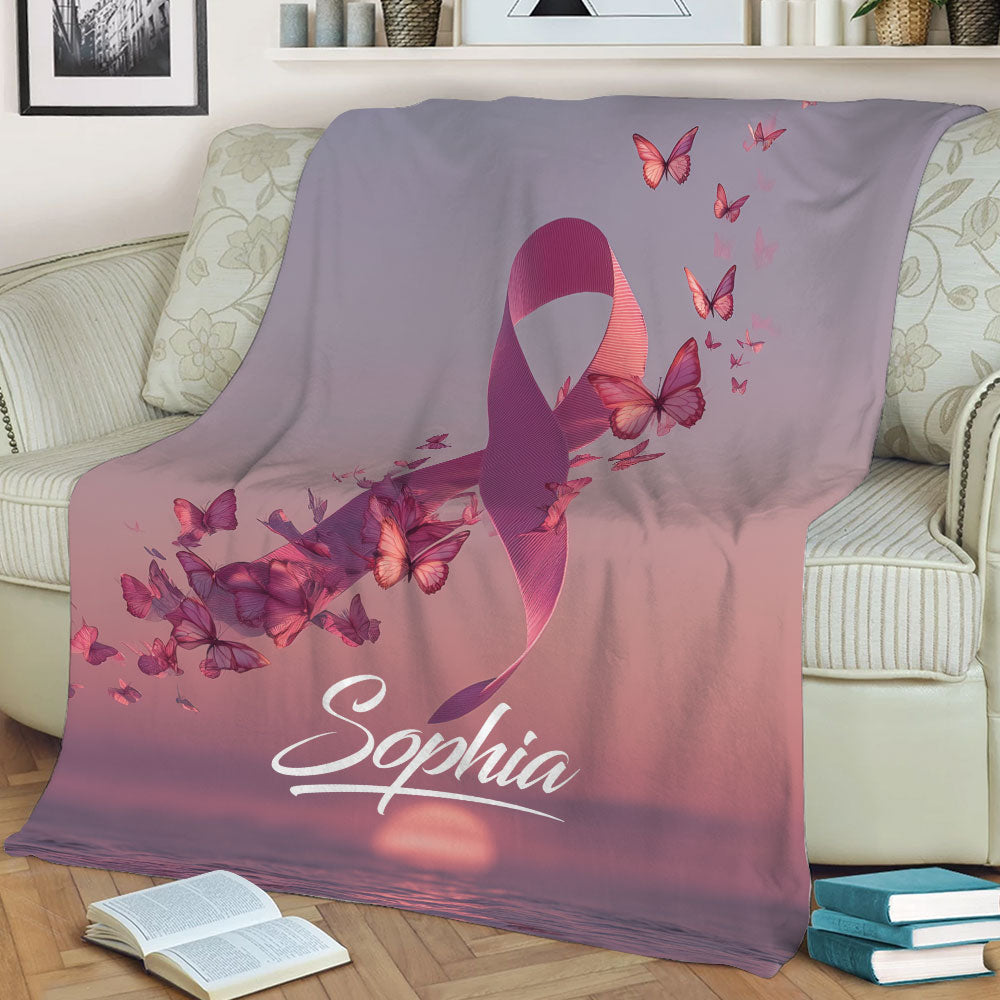Pink Breast Cancer awareness ribbon blanket styled across a living room sofa