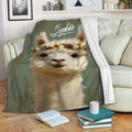 Alpaca throw blanket displayed on a sofa with floral artwork and cozy living room decor