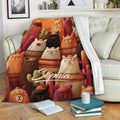 Custom alpaca throw blanket draped over a sofa with colorful desert-inspired alpaca and cactus artwork