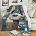 Alpaca blanket draped over a sofa with blue and ochre geometric artwork in a cozy living room