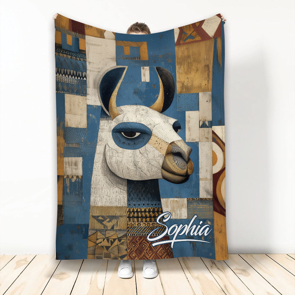 Alpaca throw blanket with a stylized animal illustration in blue, cream, ochre, and geometric patterns