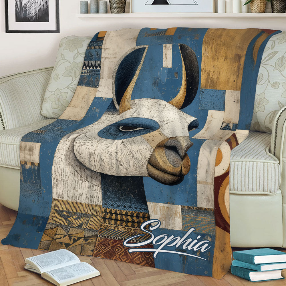 Decorative alpaca throw blanket displayed on a sofa with rustic geometric artwork and earthy colors