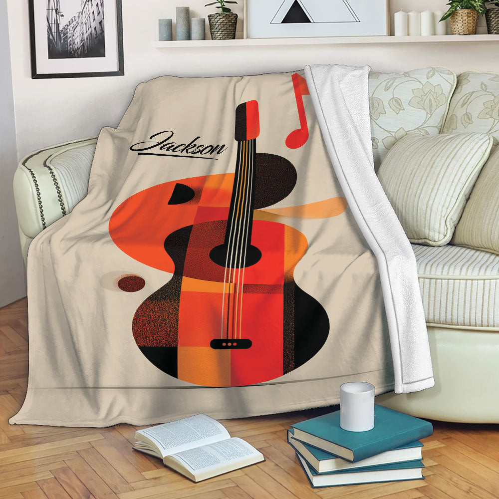 Guitar blanket draped over a sofa, featuring colorful acoustic guitar artwork in a cozy living room