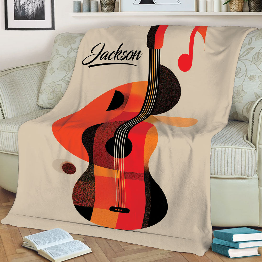 Decorative guitar throw blanket displayed on a couch with abstract acoustic guitar and music note design
