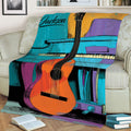 Guitar and piano artwork featured on a throw blanket styled across a sofa