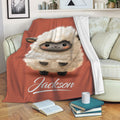 Cute sheep throw blanket draped over a sofa with cozy living room decor