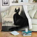 Black cat throw blanket draped over a sofa with a modern monochrome cat design