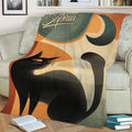 Close view of a black cat throw blanket with curved tail artwork, crescent moon detail, and retro styling