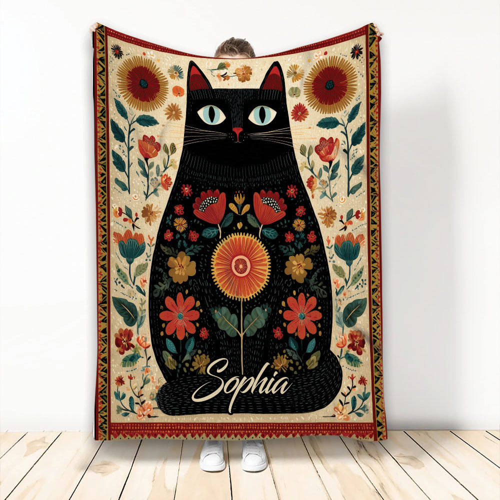 Black cat blanket with colorful floral artwork, decorative border, and folk-inspired botanical design