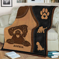 Close lifestyle view of a Goldendoodle blanket featuring curly dog artwork and brown and black accents