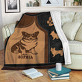 Corgi throw blanket displayed on a sofa with brown and black dog-themed artwork