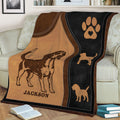 Close view of a Beagle blanket featuring illustrated dog artwork, paw print, and silhouette details