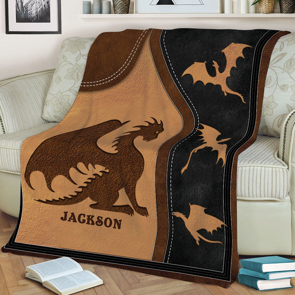 Close view of a custom dragon blanket with dramatic silhouettes and rustic brown and black tones