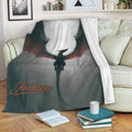 Dragon throw blanket draped over a sofa with dark fantasy artwork and red accents