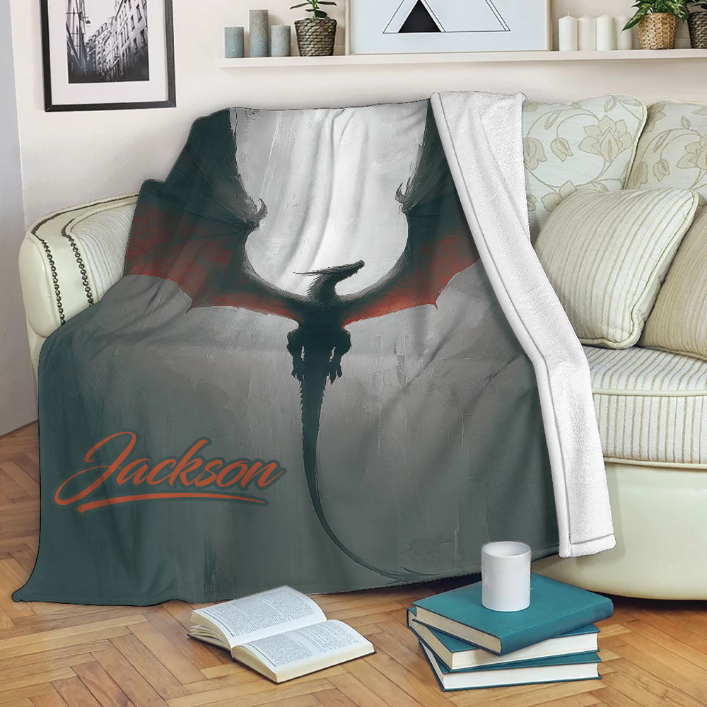 Dragon throw blanket draped over a sofa with dark fantasy artwork and red accents