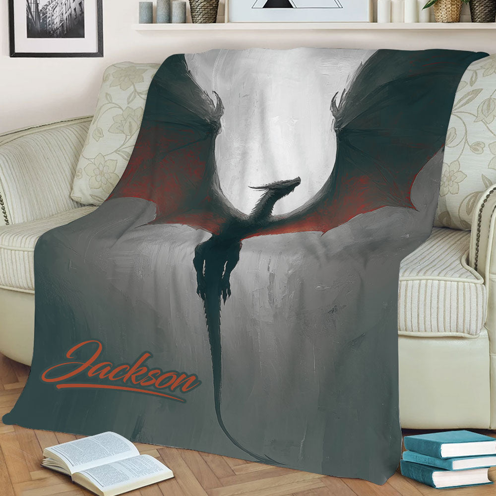 Close view of a dragon blanket displayed on a sofa with dramatic fantasy artwork