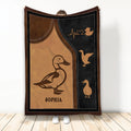 Duck throw blanket displayed upright with vintage brown and black artwork and multiple duck silhouettes