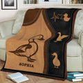Close view of duck blanket artwork on a sofa featuring a large illustrated duck and smaller duck silhouettes