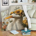 Floral duck throw blanket draped over a sofa with sunflower and garden flower artwork