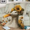 Close view of a duck blanket with detailed sunflower, daisy, and botanical artwork