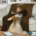 Close view of a duck in a cowboy hat on a decorative throw blanket