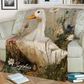 Close view of a duck throw blanket with painterly flowers displayed on a sofa
