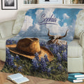 Texas longhorn and cowboy hat blanket displayed across a sofa in a cozy living room