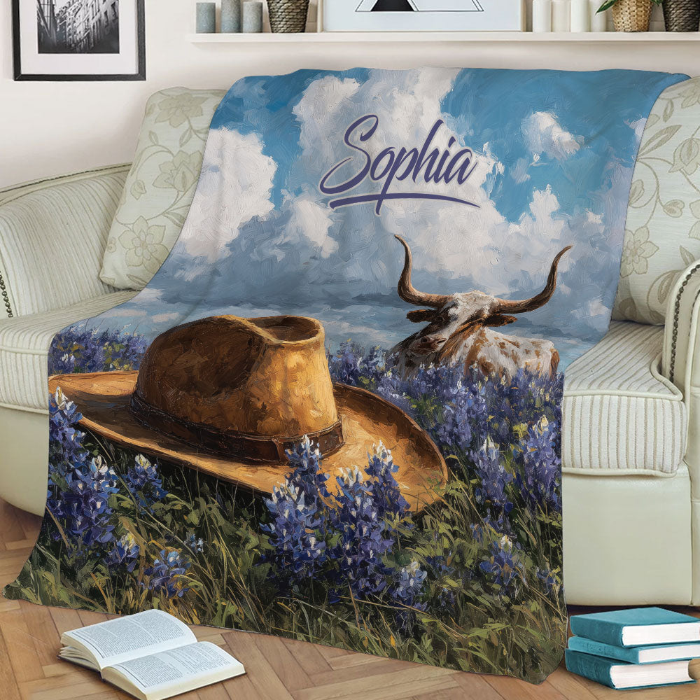 Texas longhorn and cowboy hat blanket displayed across a sofa in a cozy living room