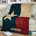 Close view of a Texas flag blanket with Lone Star design styled on a couch