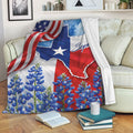 Texas throw blanket displayed on a sofa with Lone Star artwork, red white blue accents, and bluebonnets
