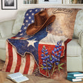Rustic Texas throw blanket displayed on a sofa with a cowboy hat, bluebonnets, and vintage flag artwork