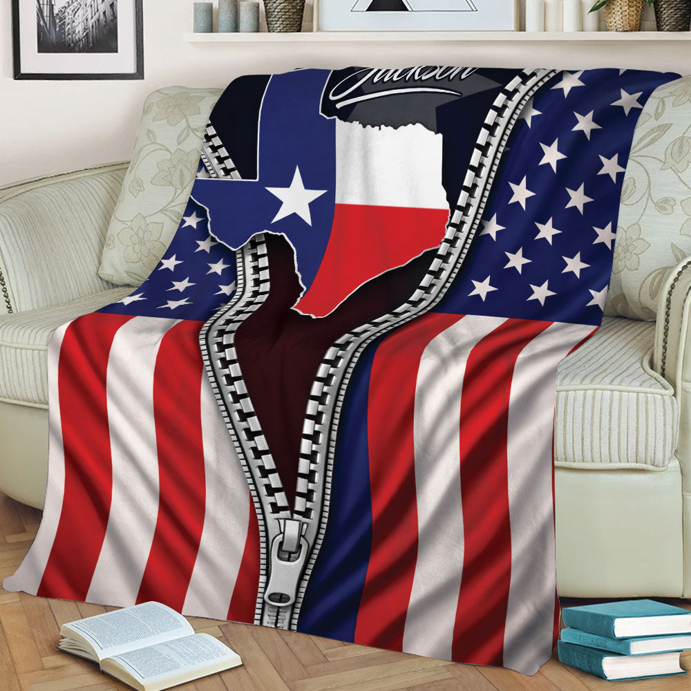 Texas pride throw blanket draped over a couch with American flag stripes and star details