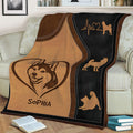 Shiba Inu throw blanket styled on a couch with brown, black, and tan dog artwork