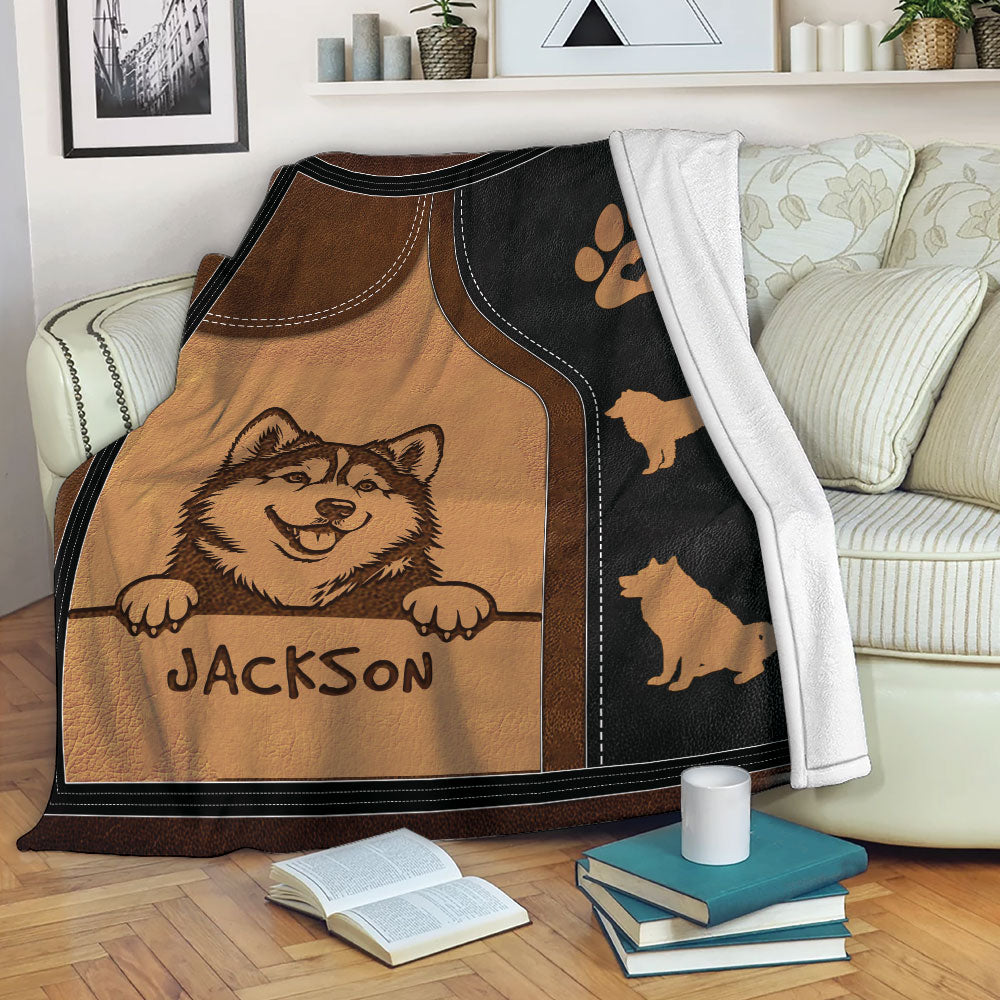 Alaskan Malamute throw blanket styled on a sofa with a smiling dog illustration and paw print accents