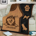 Close view of an Alaskan Malamute blanket draped over a sofa with rustic dog artwork and paw print design